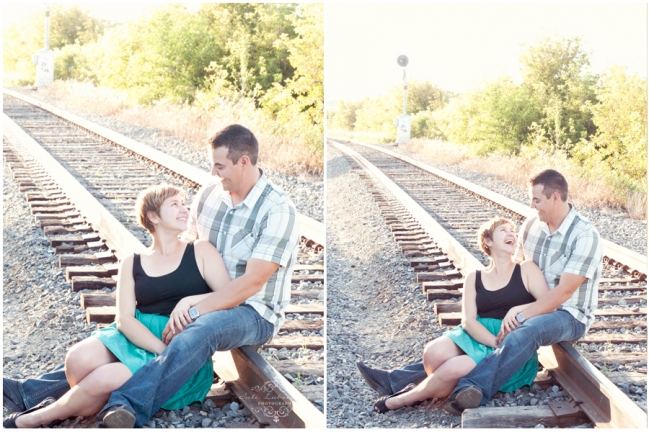 Couple sitting on train tracks