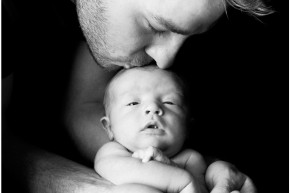 Dad kisses newborn's head