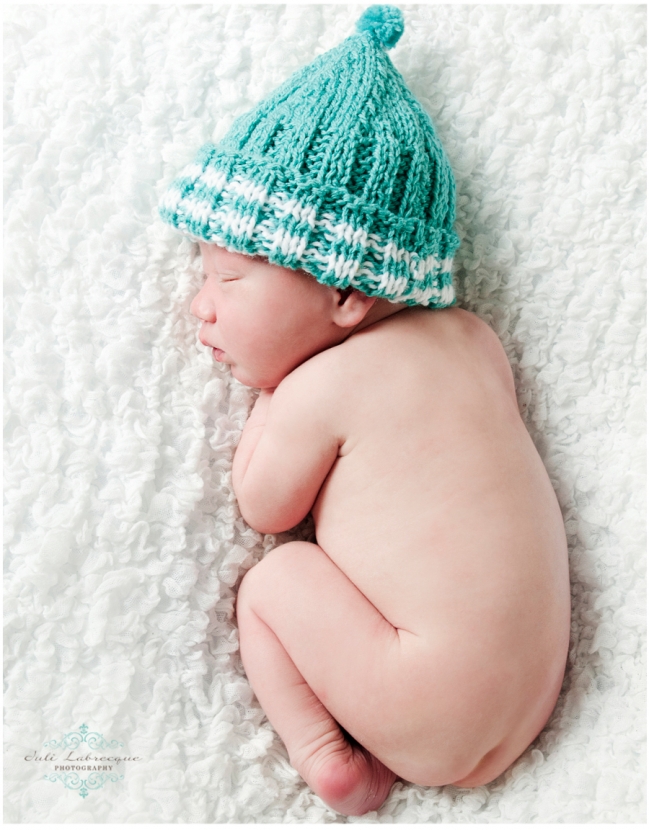 Newborn in teal touque