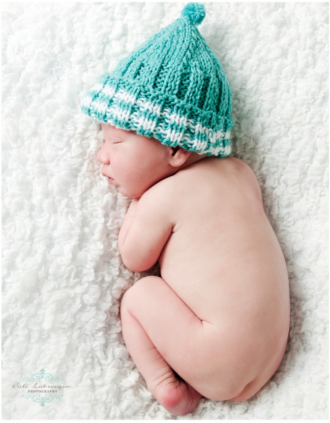 Newborn in teal touque