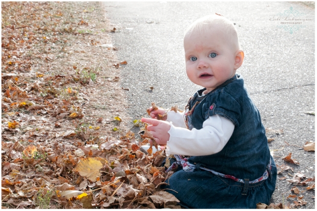 baby playing in the leaves